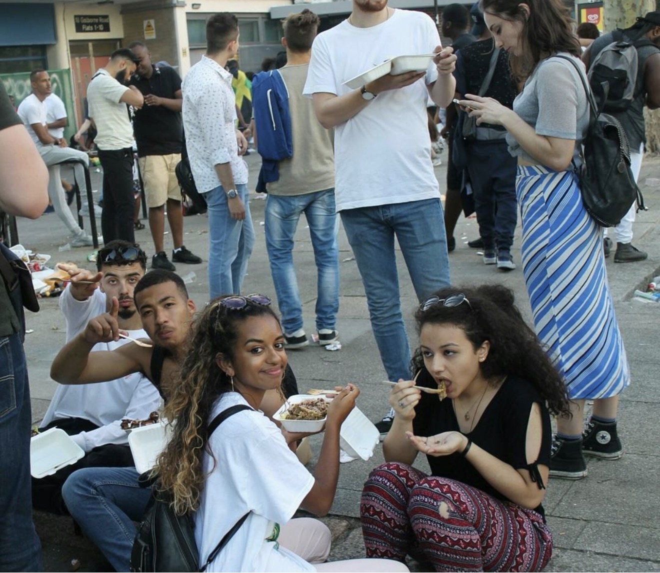 Customers enjoying The Jerk Joint food at a community event