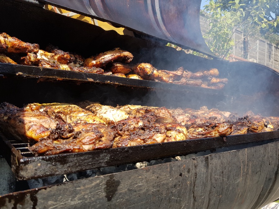 Jerk pan with smoky chicken cooking