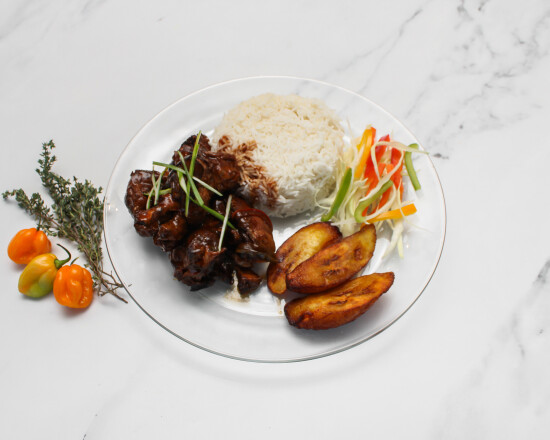 Brown stew chicken with rice, plantain and vegetables